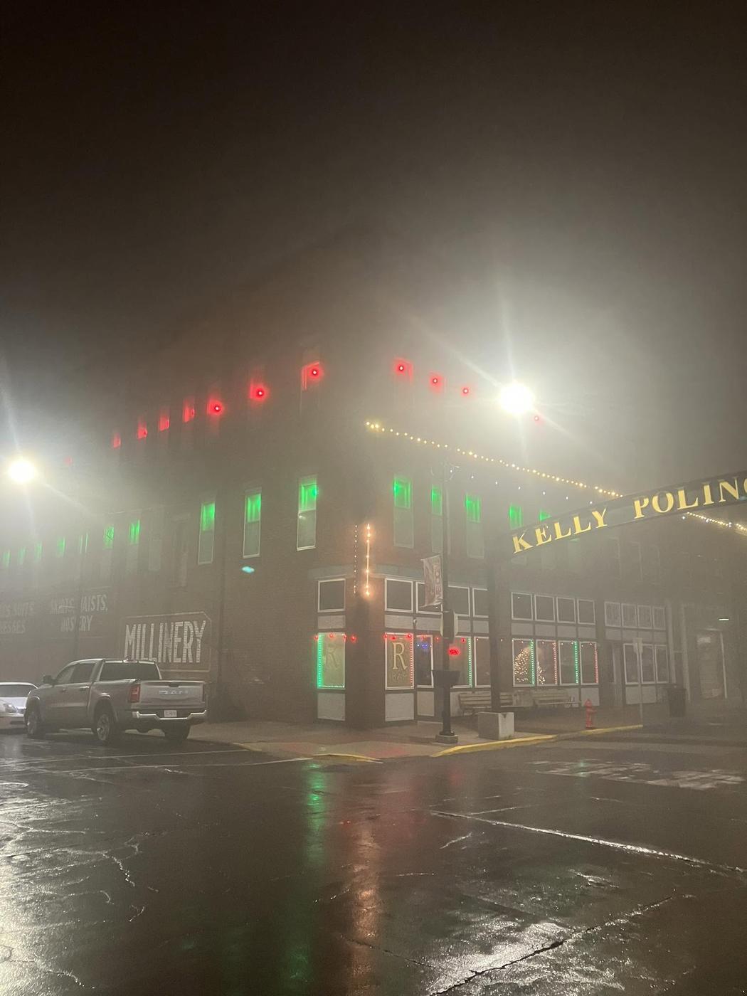 Locust Street on a foggy night, the block lit red and green under the Kelly Poling sign